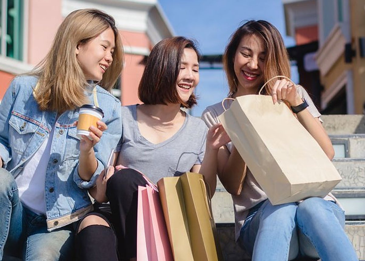 Friends sitting together with their shopping bags